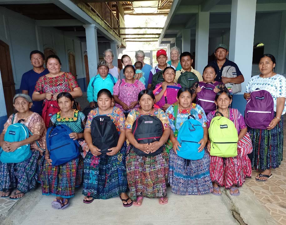 A group of midwives holding their backpacks