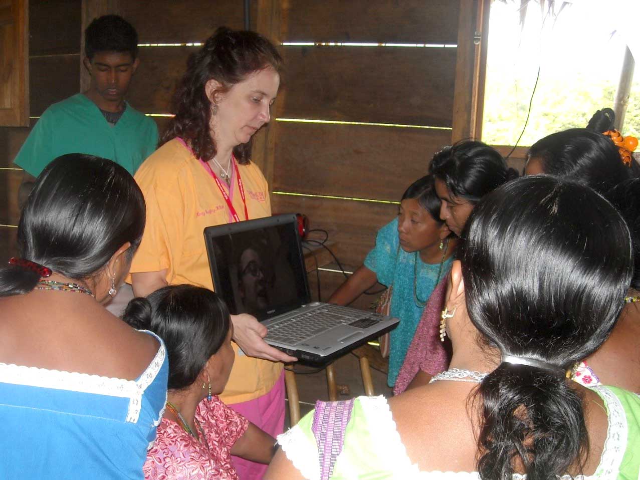 Kimberly and students gather around a laptop